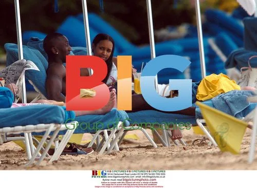 Footballer JIMMY FLOYD HASSELBAINK and girlfriend JAMELIA on beach in Barbados