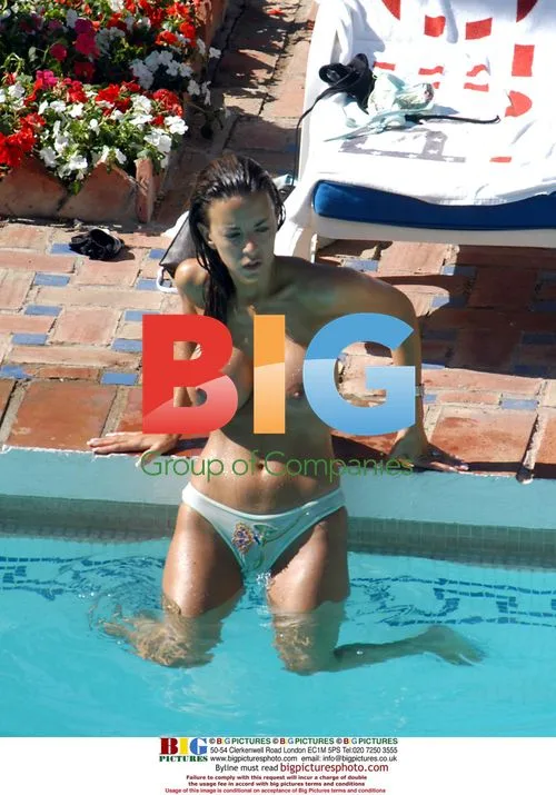 Model Lucy Becker Tanning by Pool in Spain