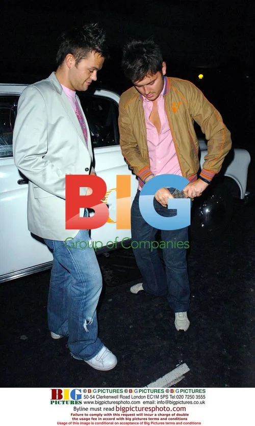 TV Presenter Brian Downing and Friend Searching for Taxi Fare