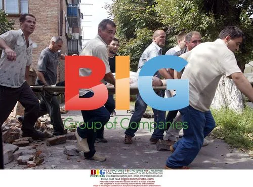 Volunteers Carry Injured Child After Beslan School Siege