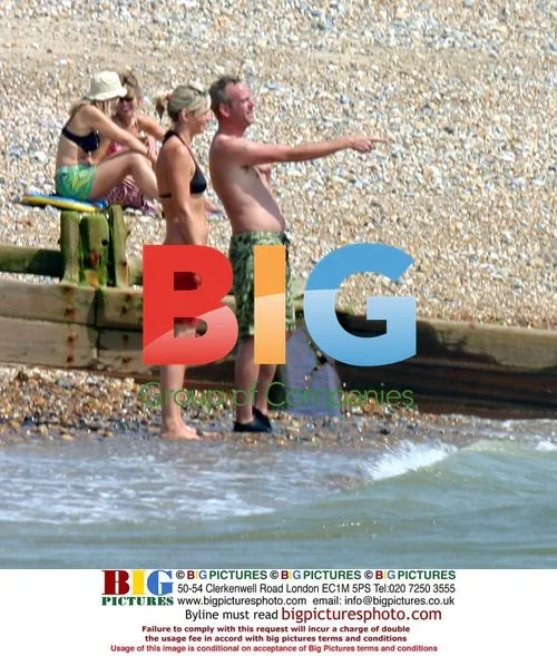 Fatboy Slim and Zoe Ball play in the sea
