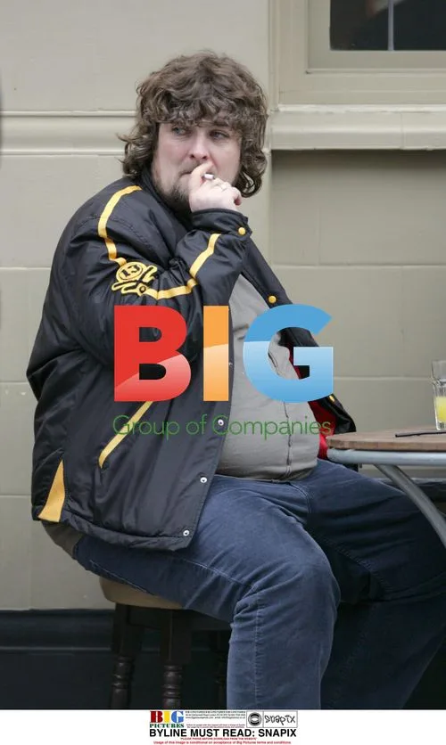 Paul Gallagher Enjoys Drink and Cigarette