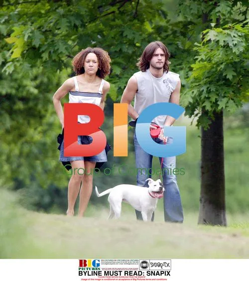 Alex Sibley and Melanie Hill walk dog in park