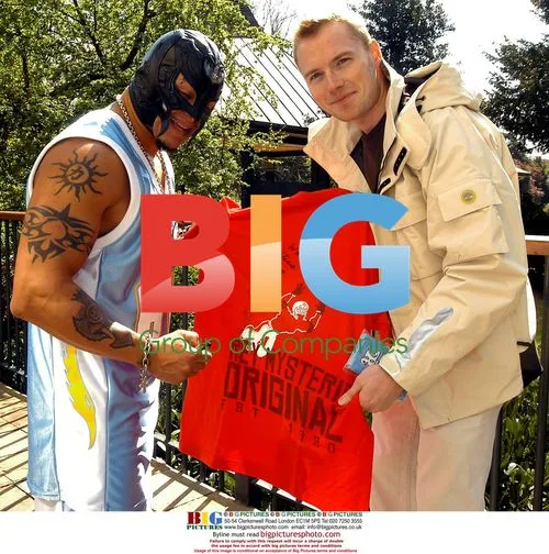 Ronan Keating poses with WWE stars