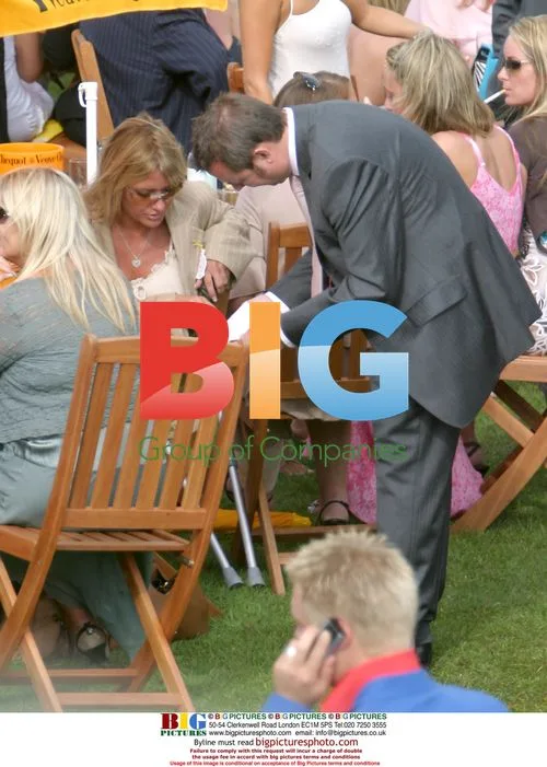 Alex Best Enjoys Cigar and Wine at Goodwood Horse Race