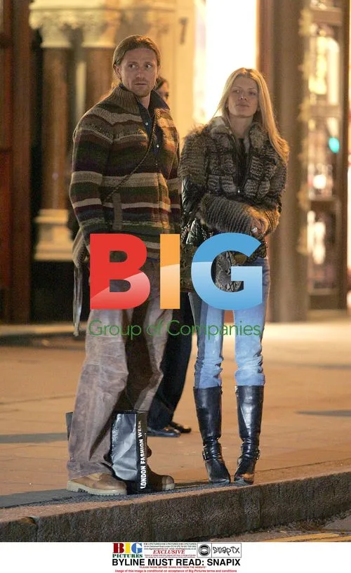 Footballer Emmanuel Petit and girlfriend shopping in London