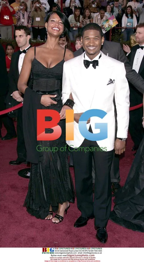 USHER and guest at 77th Oscars