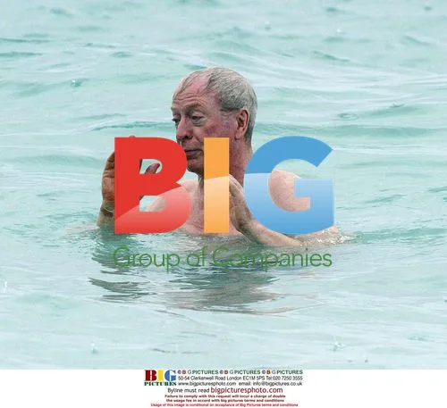 Michael Caine takes stroll on Barbados beach