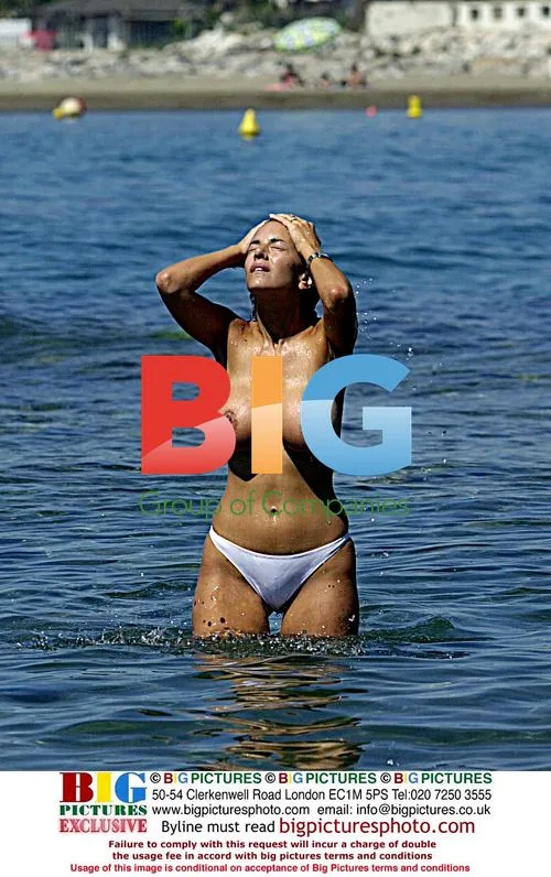 Model Lucy Becker Tanning by Pool