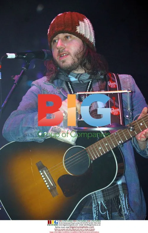 Badly Drawn Boy Holds Harmonica at Love from Manchester