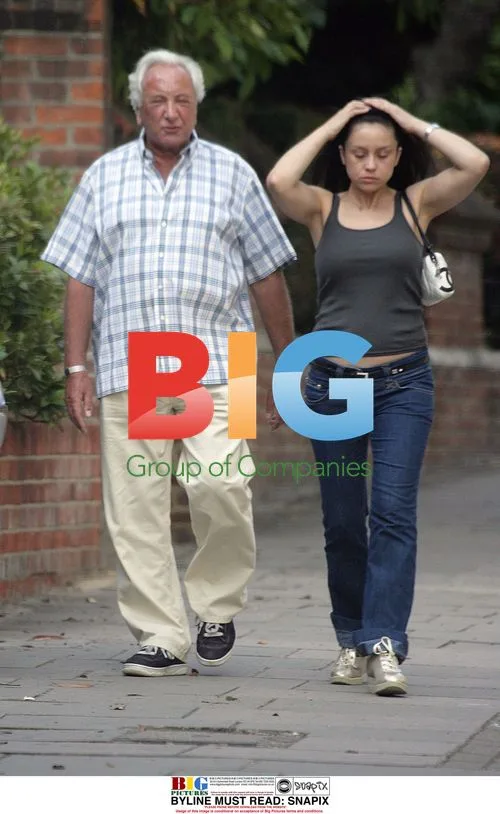 Michael Winner strolling with dining partner