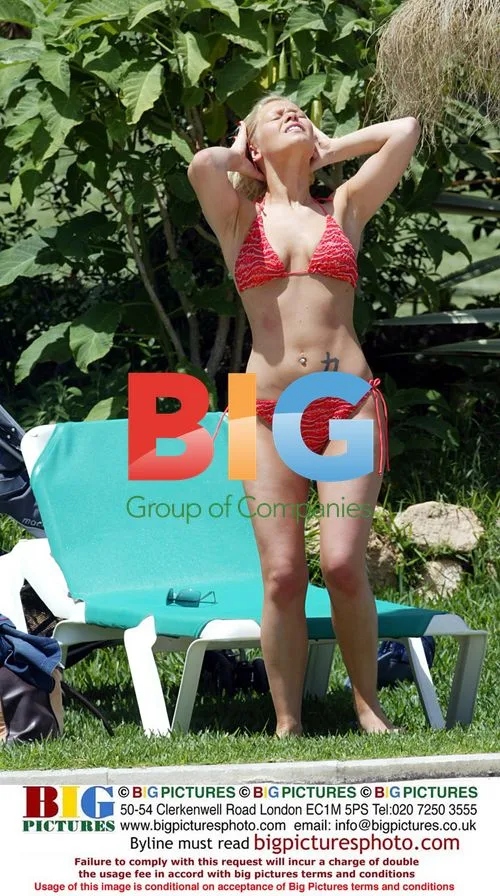 Singer Suzanne Shaw Sunbathes by Pool