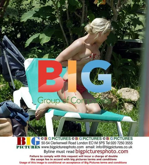 Singer Suzanne Shaw Sunbathes by Pool