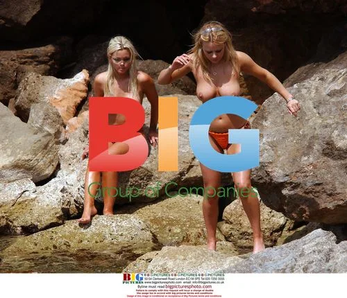 Glamour models Tara and Delta play on rocks