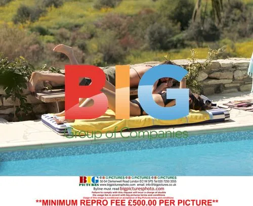 Rebecca Loos and friend relax poolside in Cyprus