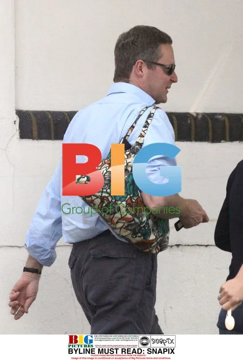 Rory Bremner carrying wife's bag