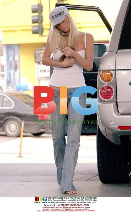 Paris Hilton Pumps Gas with Puppy