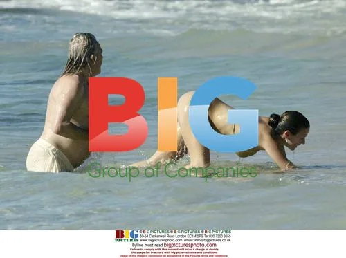 Peter Stringfellow and girlfriend on Barbados beach