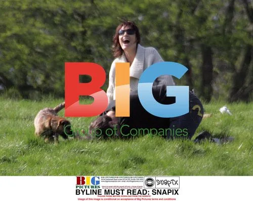 Sarah Parish walks dog with boyfriend