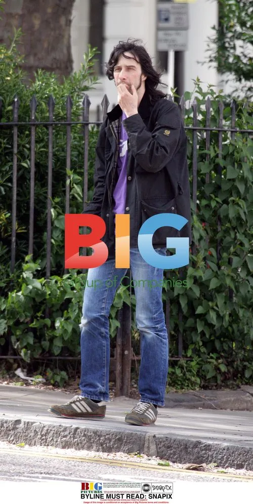 Bobby Gillespie looks pensive waiting for cab