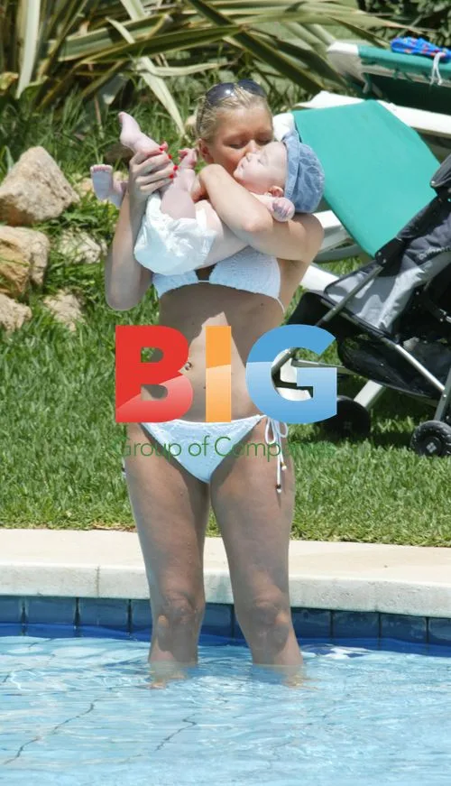 Suzanne Shaw Relaxes with Child on Holiday