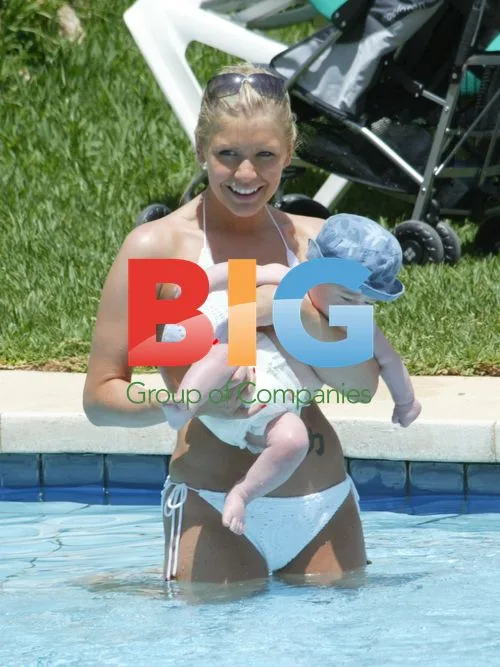 Suzanne Shaw Relaxes with Child in Pool