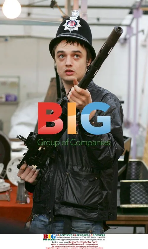 Pete Doherty poses with policeman's helmet