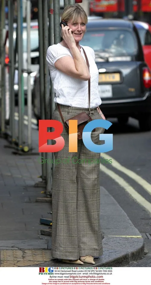 Sarah Lancashire hails taxi in London