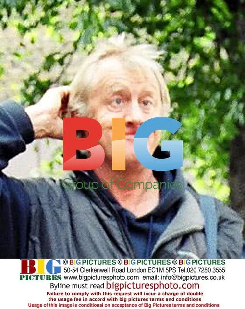 TV presenter Chris Tarrant entertains photographers