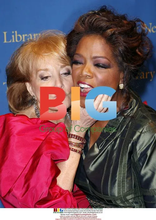 Barbara Walters pinches Oprah's face at NYC gala