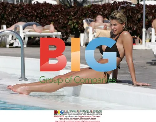 Gemma Atkinson relaxes poolside in bikini
