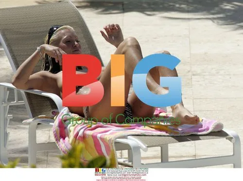 Model Caprice relaxes on holiday