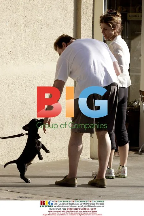 Schwarzenegger and Shriver Play with Puppy