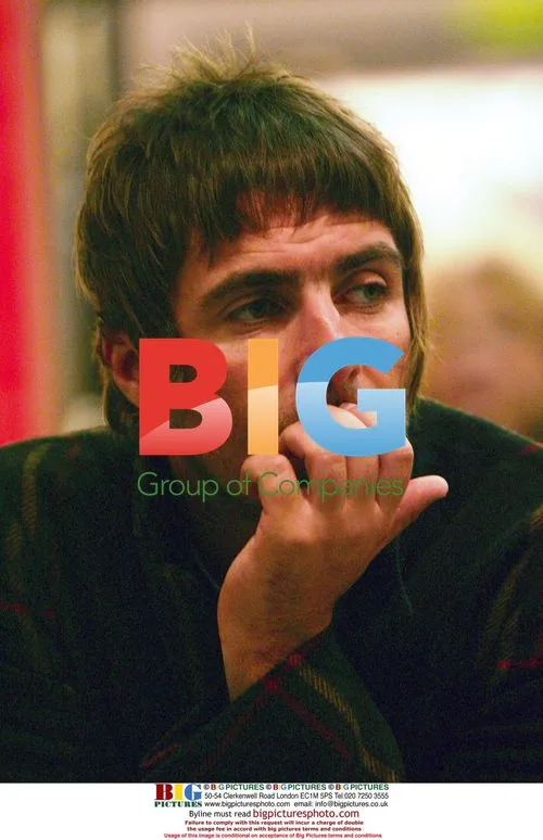 Liam Gallagher waits with shopping at Harrods