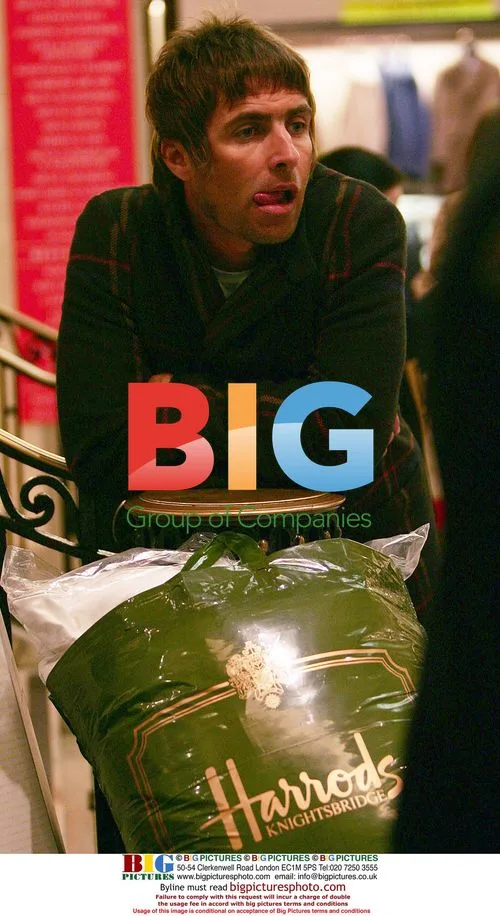 Liam Gallagher waits with shopping at Harrods