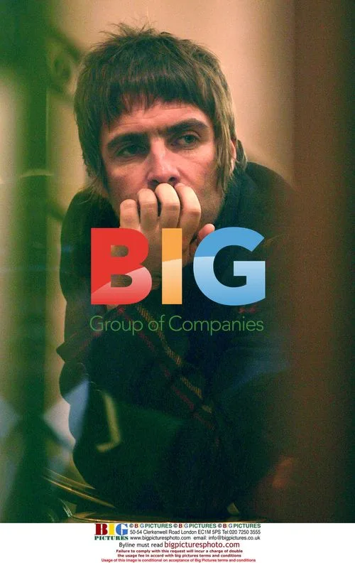 Tired-looking Liam Gallagher waits inside Harrods