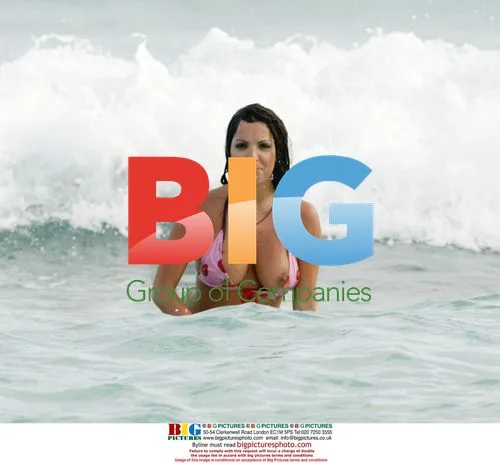 Glamour model Coralie surfs in the Caribbean