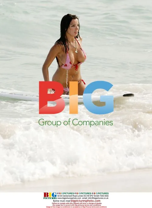 Glamour model Coralie surfing in Caribbean