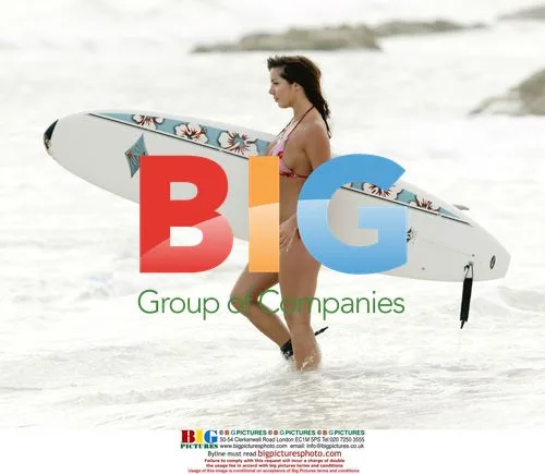 Coralie surfs in the Caribbean