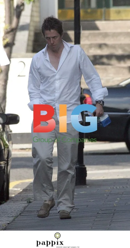 Hugh Grant Arrives Home with NHS Bag