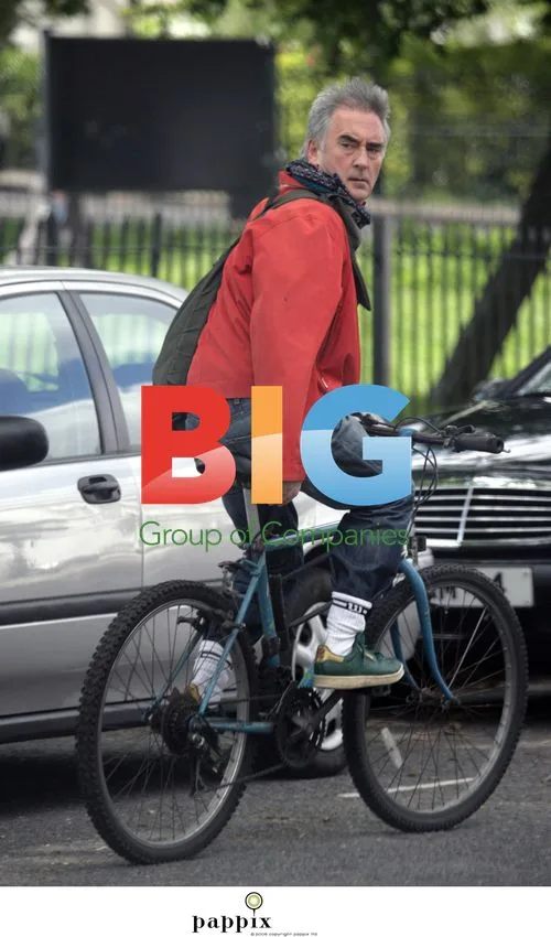 Dennis Lawson riding bike in London