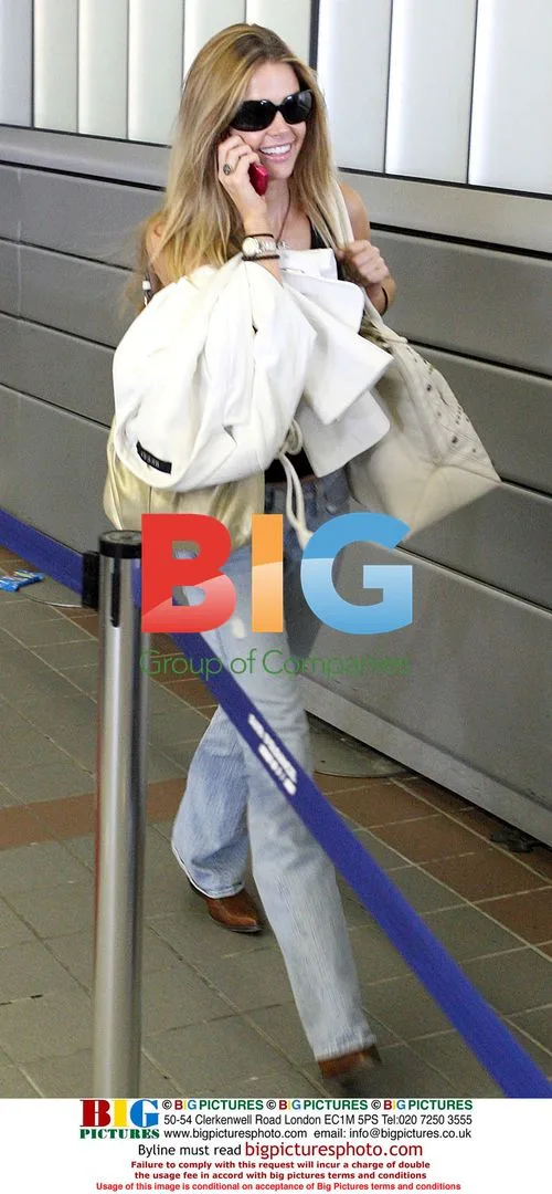 Denise Richards boards plane at LAX