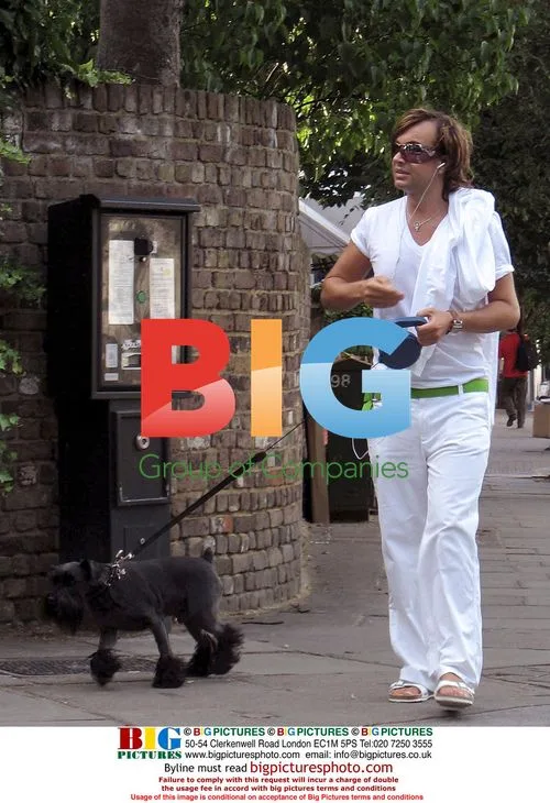 Julian McDonald walks poodle in London