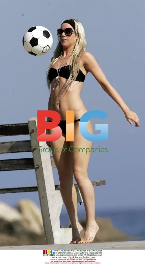 Kate Lawler shows off football skills on beach