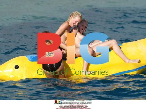 Glamour girls fool around on inflatable banana