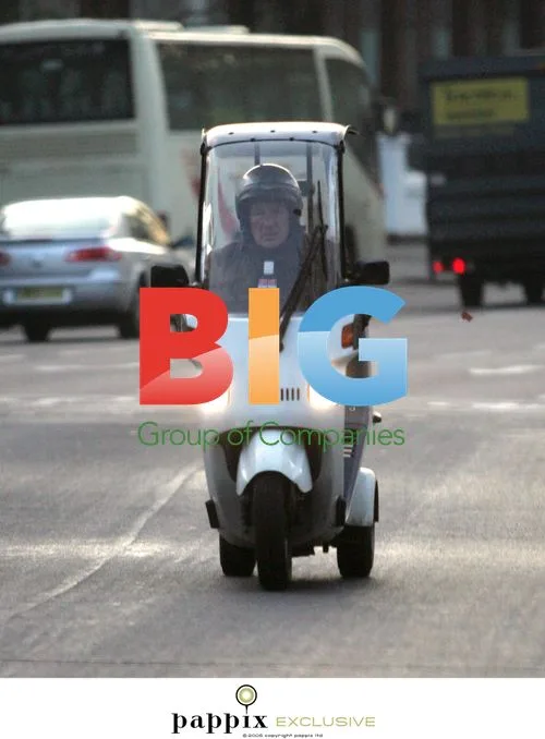 Sir Sterling Moss on 3-Wheeled Moped in London
