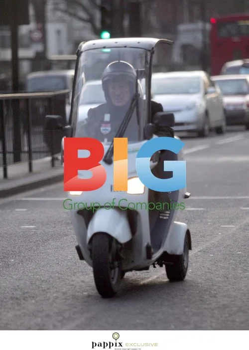 British F1 Legend Sir Sterling Moss on 3-Wheeled Moped