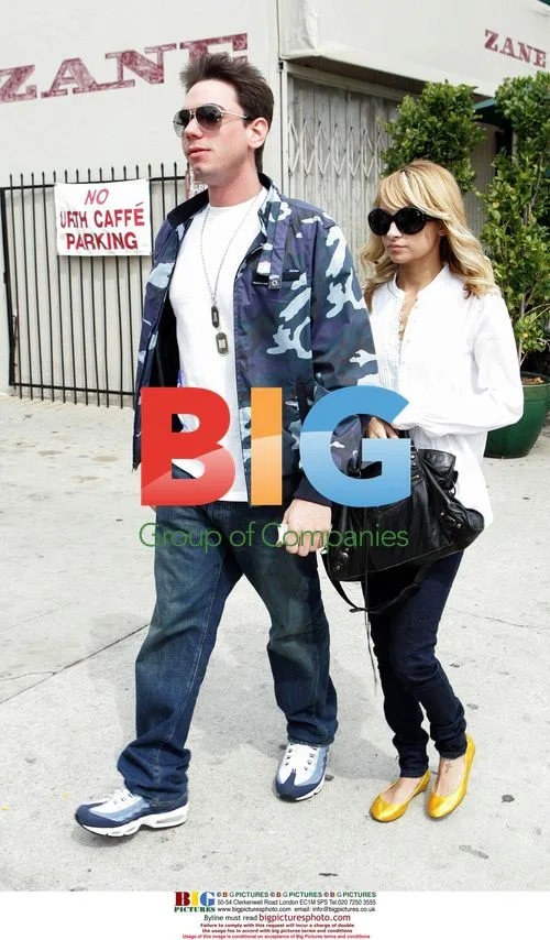 Nicole Richie and Adam Goldstein hold hands