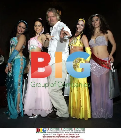 Richard Branson Poses with Belly Dancers