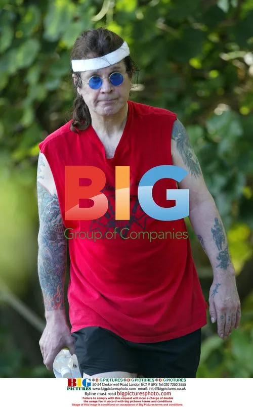 Ozzy Osbourne gets camera shy on walk